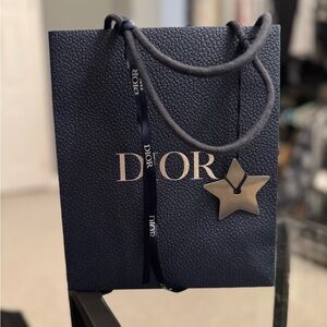 Navy Dior shopping bag with ribbon and metal star emblem